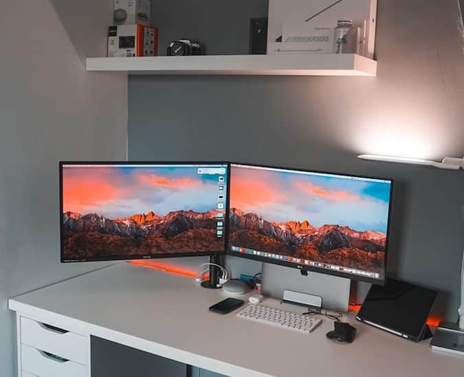 two flat screen computer monitors inside room